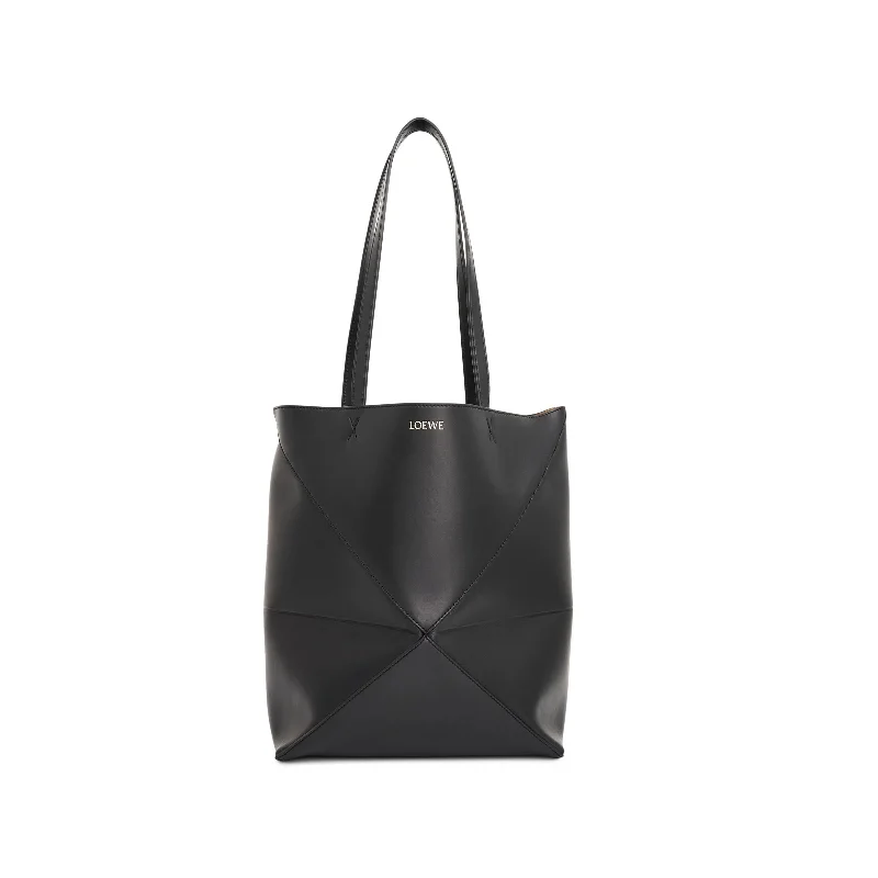 women's handbag with embossed logo design -Medium Puzzle Fold Tote Bag in Black